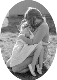a mother and daughter holding each other while the moment comforts the daughter