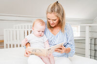 Newborn caregiver reading a book to a newborn