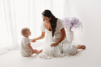 Charleston Motherhood Photographer - Mother poses with her baby during studio Mother's Day Mini Sessions at Holy City Babies Portrait Studio in Charleston, SC.