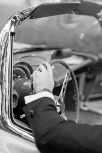 Groom with his hand on the wheel