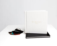 Luxury custom photo album with gold embossed name and leather swatches on display, Kaitlyn Dawn Photography, Yucaipa newborn photographer.