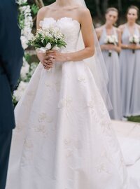 bride-white-dress-with-bouquet-her-hands-stands-groom-lawn