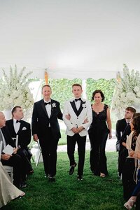 groom walking down aisle