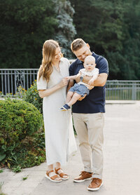 Parents and baby enjoying early morning in Toronto park.