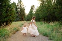 Kid running through a meadow during a playful family session in Central Oregon
