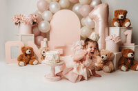 Charleston Cake Smash Photographer- Baby looks into the camera during Cake Smash Photos at Holy City Babies Portrait Studio in Charleston, SC.