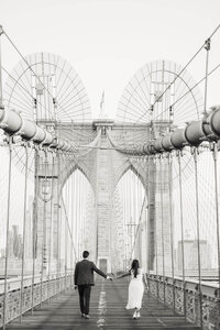 A timeless black and white portrait of a couple by the East River, capturing a genuine connection during their multi-day wedding celebration.