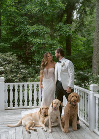 Bride and groom share first look with their dogs, dressed in black tie, at their Highlands, NC wedding.