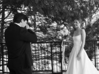 Black and white photo of the groom becoming emotional as he sees the bride for the first time during their wedding day at Burritt on the Mountain in Huntsville, Alabama, photographed by Perry Hancock.