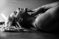 Boudoir experience studio hand running down on chin