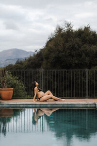 Pregnant woman at the pool during a maternity photoshoot in Christchurch