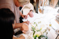 Close-up of the marriage license signing at New York City Hall with the bride, groom, and witness, photographed during Japna and Chris’s intimate elopement by NYC wedding photographer Perry Hancock.