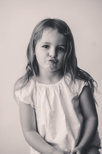 Little girl makes a silly face at the camera during Personality Portrait Session in Charleston, SC.
