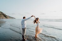A couple dancing at the beach while being photographed by Tauranga and Hamilton based photographer Haley Adele Photography