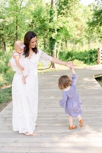 mom dancing with daughter during their family picture in Leesburg, Virginia taken by a Loudoun County, VA family photographer
