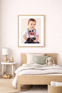 light wooden framed portrait of toddler new bern photo session hanging above toddler bed