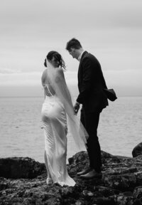 Vancouver Wedding Photographer captures couple walking cliffside during bridal portraits