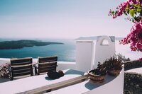 Breathtaking cliffside terrace in Santorini overlooking the Aegean Sea, ideal for romantic luxury travel.