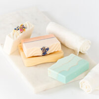 Styled product photography of artisanal soap bars photographed with soft linens and minimal props in a clean, editorial flat lay