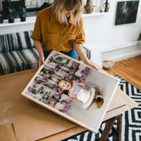 Client holding framed portrait of baby girl cake smash session in a cozy home setting, Kaitlyn Dawn Photography, Yucaipa family photographer.