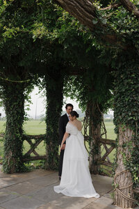 Elegant editorial couple portrait showcasing sophisticated wedding photography at Connecticut luxury destination venue. NYC photographer Lauren Alatriste captures fashion photography composition while maintaining authentic emotional connection, creating imagery that transcends traditional documentation.
