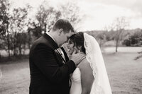 bride and groom embrace during their catholic couples portraits