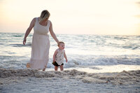 mom and child on marco island beach by the water at sunset