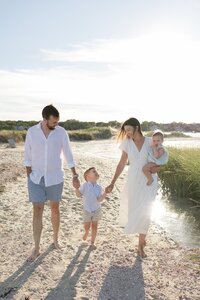 A coastal New England family session with toes in the sand and salty snuggles by the water's edge. North Shore Family Photographer. Deborah Zoe Photography.