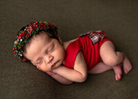 detail photo of a newborn baby girl's feet with the body faded in the background.