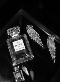 Editorial wedding photography photo of a bottle of Chanel perfume and  earrings taken by a Philadelphia wedding photographer