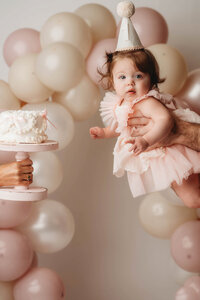 Charleston Cake Smash Photographer -- Baby celebrates her first birthday with a Cake Smash Photoshoot at Holy City Babies Portrait Studio in Charleston, SC.