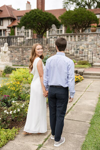 woman smiling while holding mans hand at Bloomfield Hills Engagement Photography