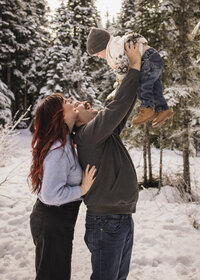 Family of 3 playing in the snow on mount hood