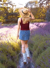 High school senior walking away in a lavender field