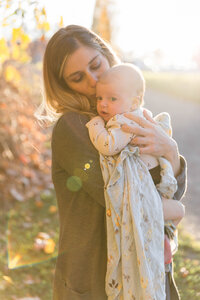 Light airy portrait of a mother holding a very young child