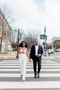 couple engagement running through dc streets