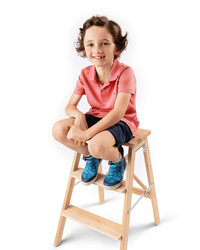 Young boy seated on stool in studio portrait session in New Bern NC