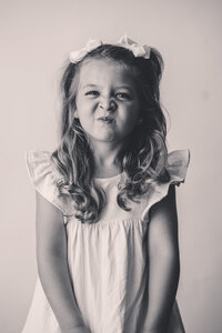 Little girl makes a silly face at the camera during Personality Portrait Photoshoot in Charleston, SC.