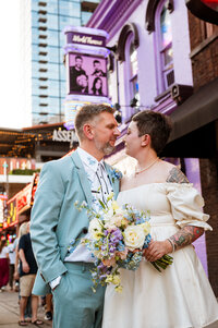 Newlyweds standing outside Tootsies on Broadway after their elopement with Nashville Elopement Company
