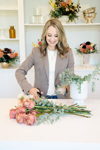 Florist cutting roses on a counter