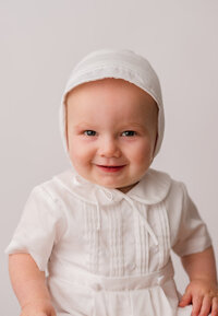 Heirloom Photographer in Charleston - Baby looks at the camera during Heirloom Photoshoot at Holy City Babies Portrait Studio in Charleston, SC.