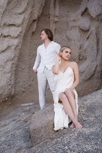 Bride and groom on beach rocks