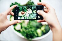 person-taking-photo-of-bowl-of-vegetables-1580470