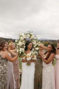Bride smiling at Bridesmaids at Renback Barn. Florals: Flowergirl Cville. Photography: Brittany Stark Studios.