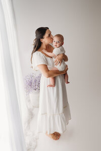Charleston Motherhood Photographer - Mother poses with her baby during studio Mother's Day Mini Sessions at Holy City Babies Portrait Studio in Charleston, SC.