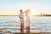 Couple in warm natural light dancing during their engagement session at Murrell Park with Graceful Ray Photography.