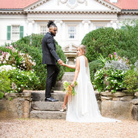 Bride and groom at Hills & Dales Estate in La Grange Georgia, with the bride descending an elegant stone staircase