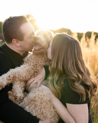 couple kissing dog by wedding photographer georgia