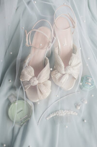 heels and perfume underneath a translucent wedding veil