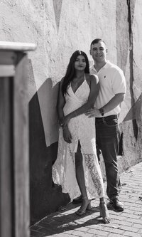 Engaged couple posing for a engagement photo session in Marietta Square
